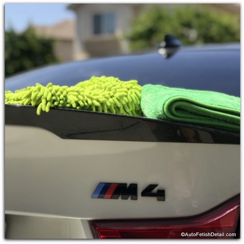 chenille wash mitt and micro-fiber cloth on white BMW M4 best way to clean BMW M4 car